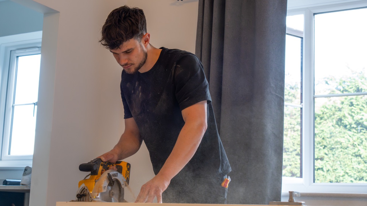 Bramer's Flooring fitter providing door cutting service on-site in Warwickshire